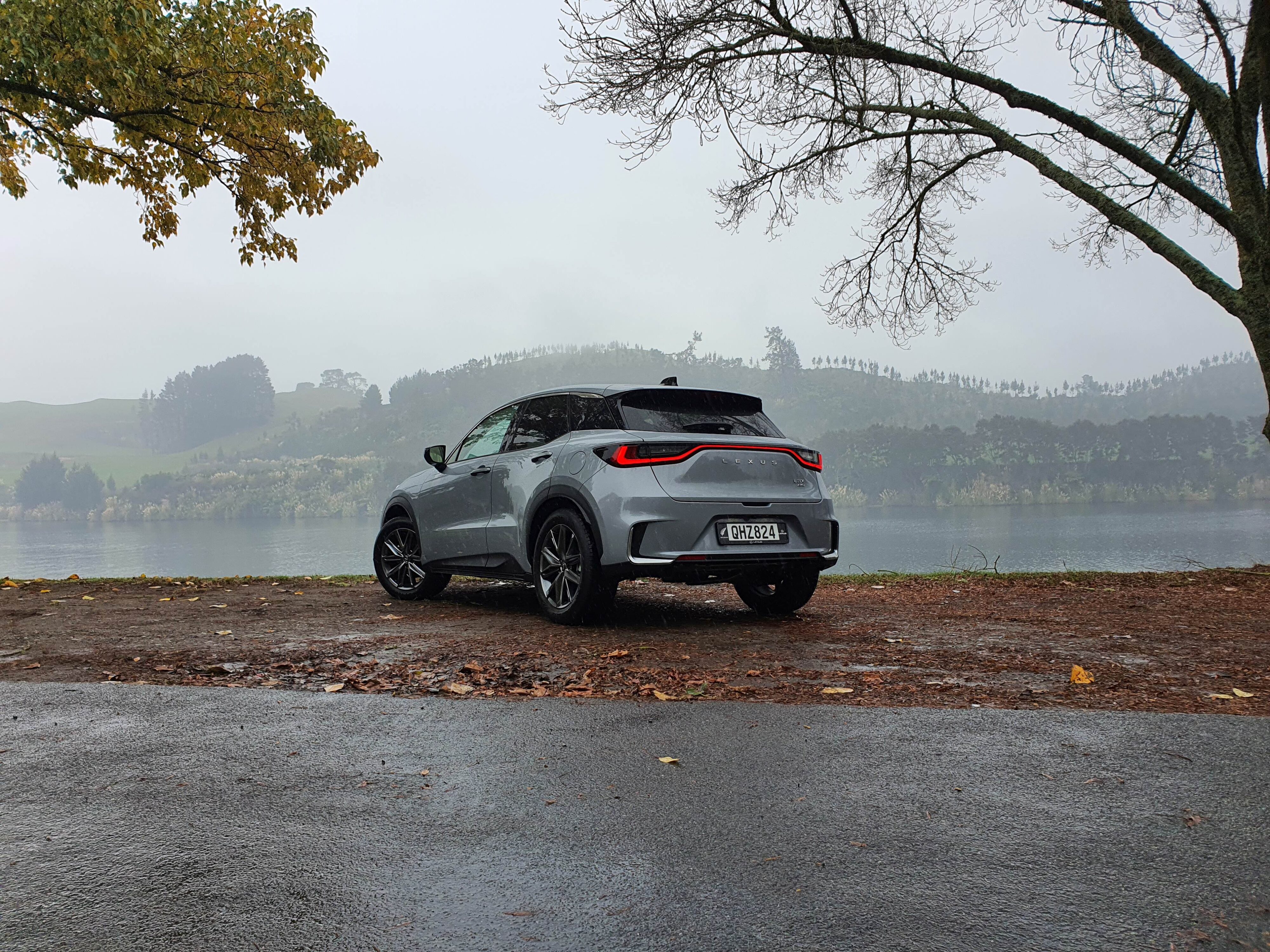 Rear three quarters view of a 2024 Lexus LBX Relax AWD in Concrete Grey.