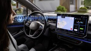 A promotional photo of a woman interacting with the voice command technology inside a Volkswagen car.