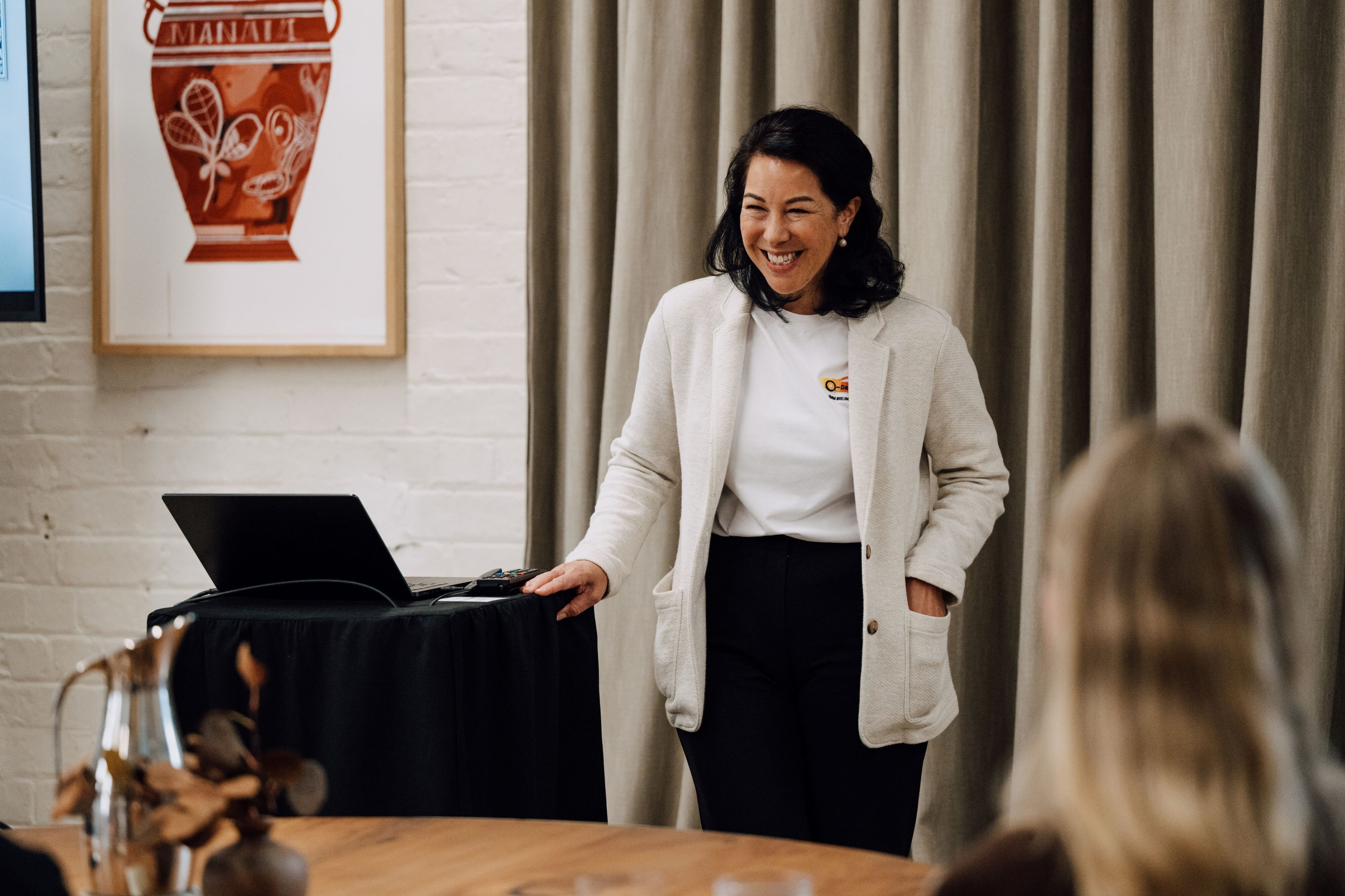 Dr Stella Clarke presenting to a room of journalists at The Hotel Britomart in Auckland, New Zealand.