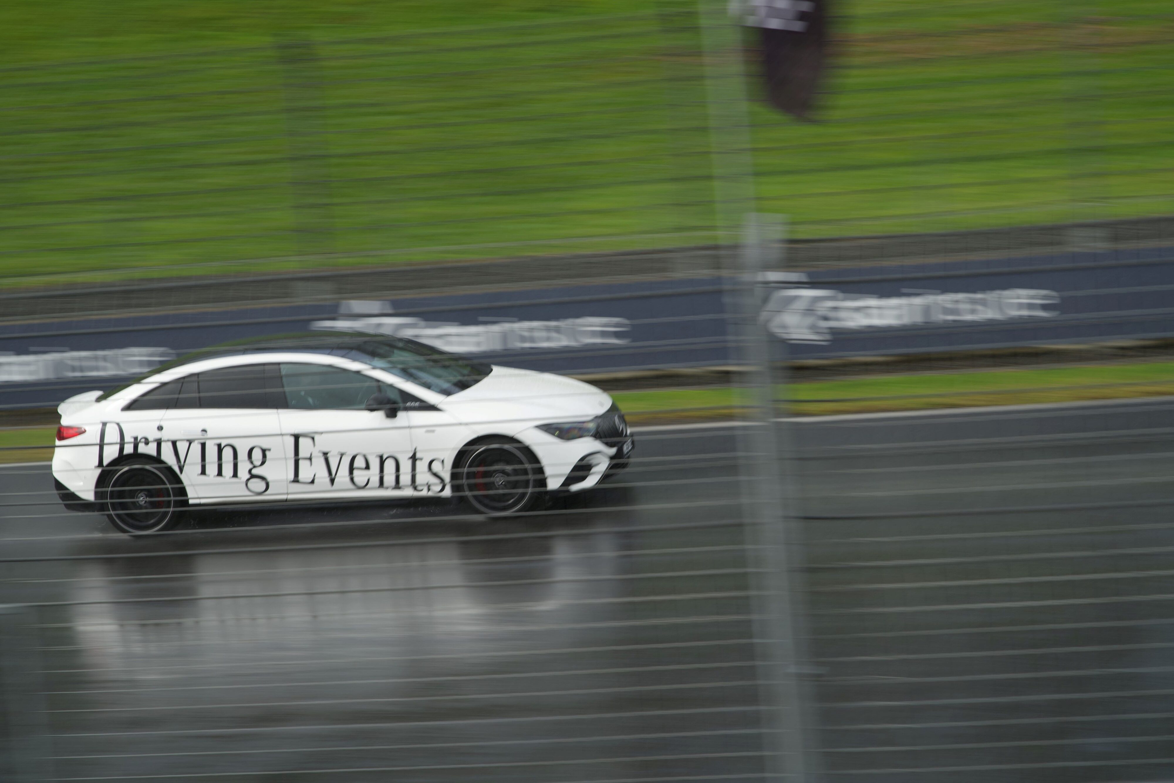 A Mercedes-Benz EQE53 AMG going around a wet Hampton Downs at the Mercedes Benz Driving Event in August 2024.