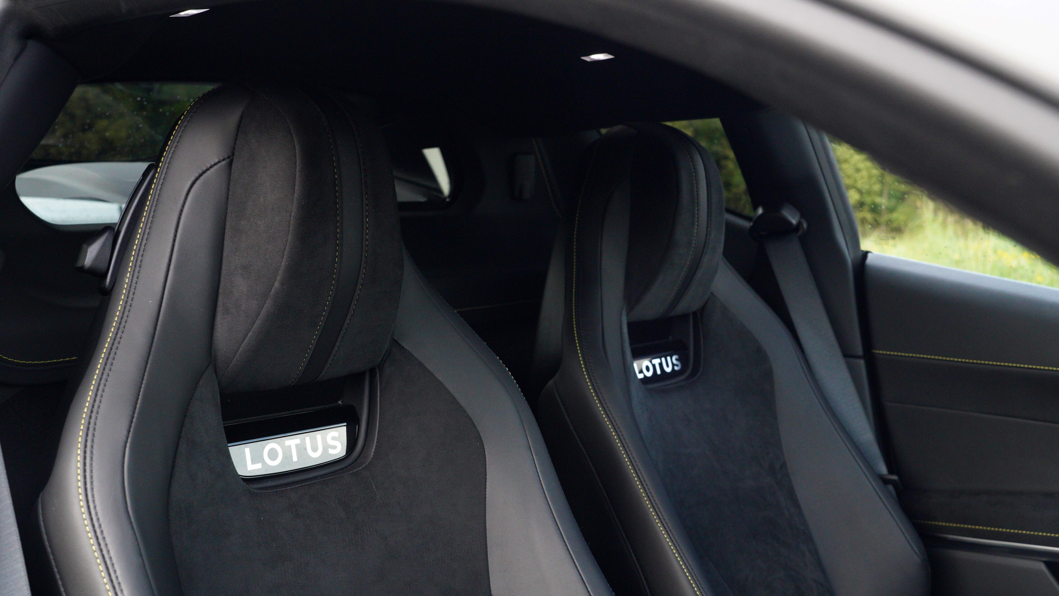 Photo of the sports seats on the inside of a 2024 Lotus Emira i4 Turbo with Lotus displayed on the seatbacks. 