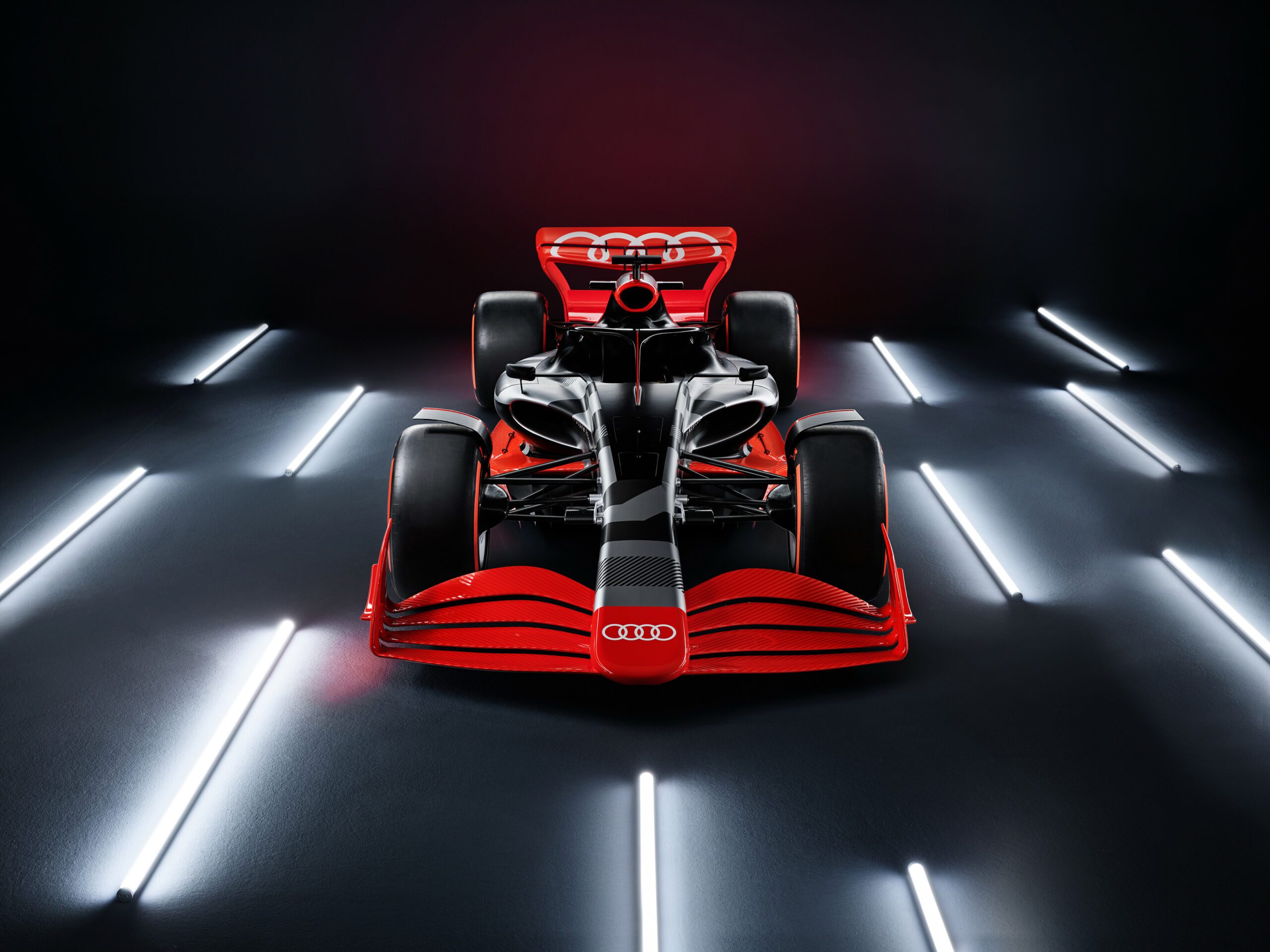 An Audi F1 Team car in a stylistic photoshoot background.