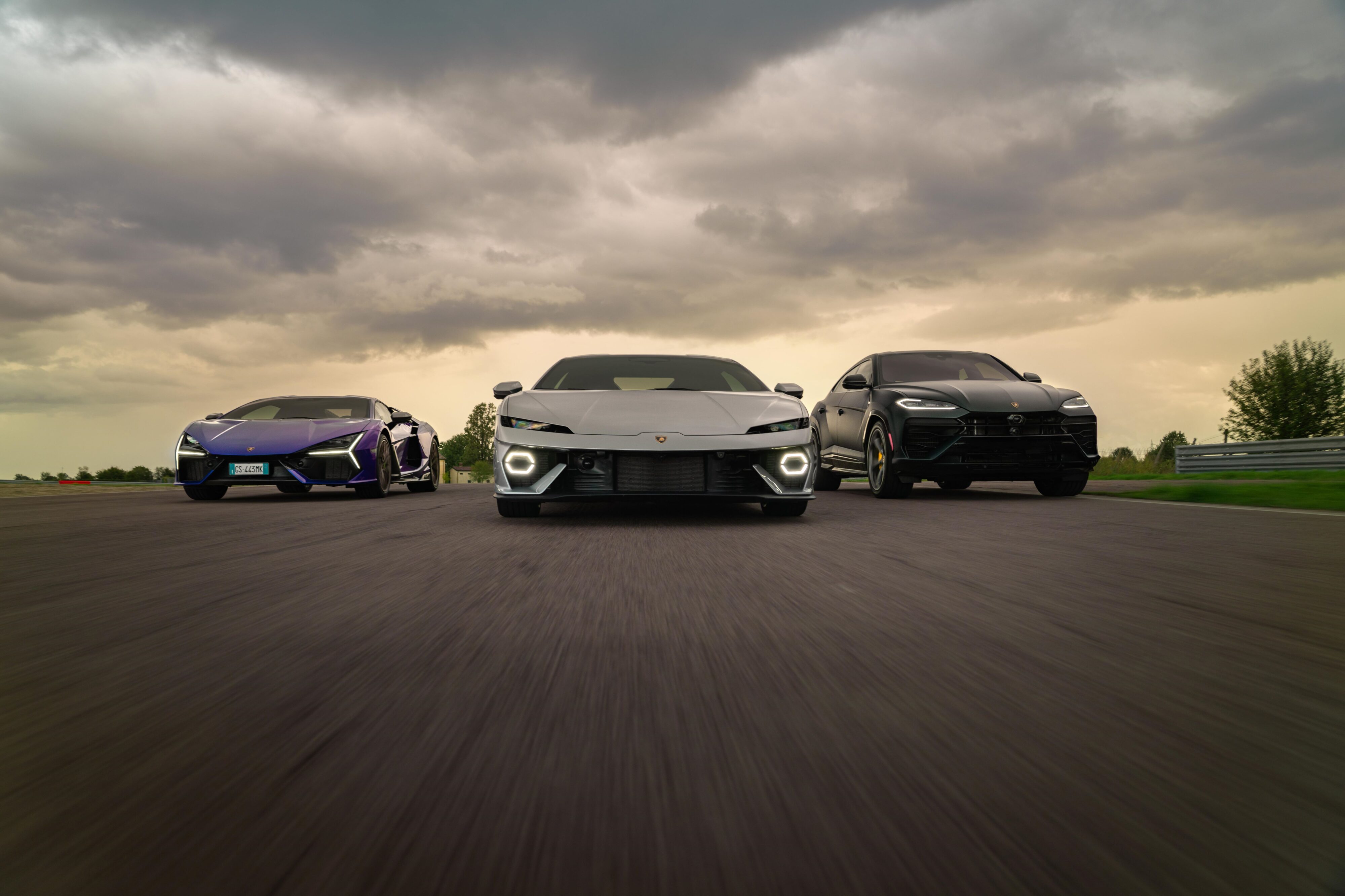 A rolling shot of a Lamborghini Temerario, Urus and Revuelto together.