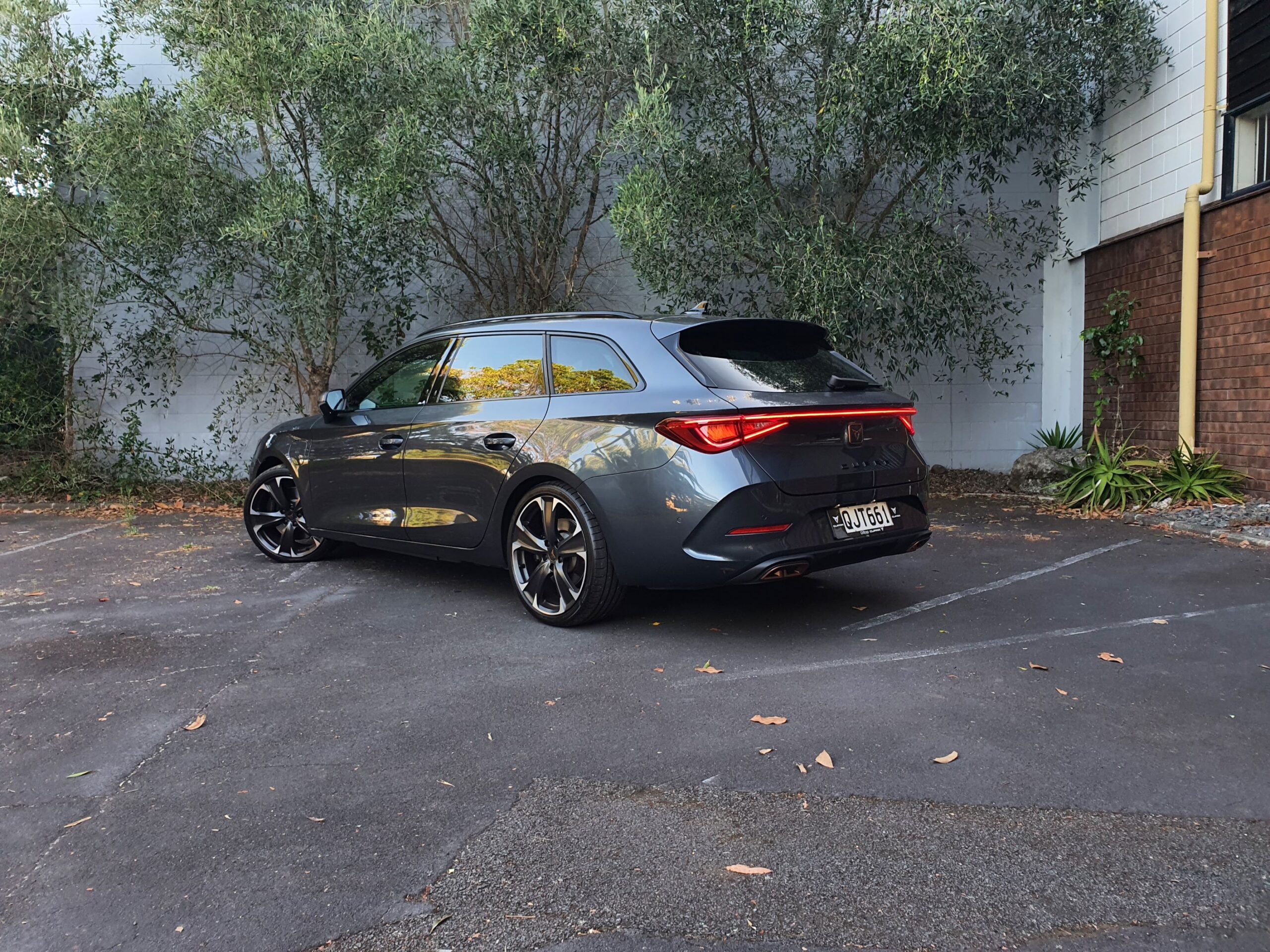 Rear three quarters view of a 2024 Cupra Leon V Sportstourer e-HYBRID in Magnetic Tech.