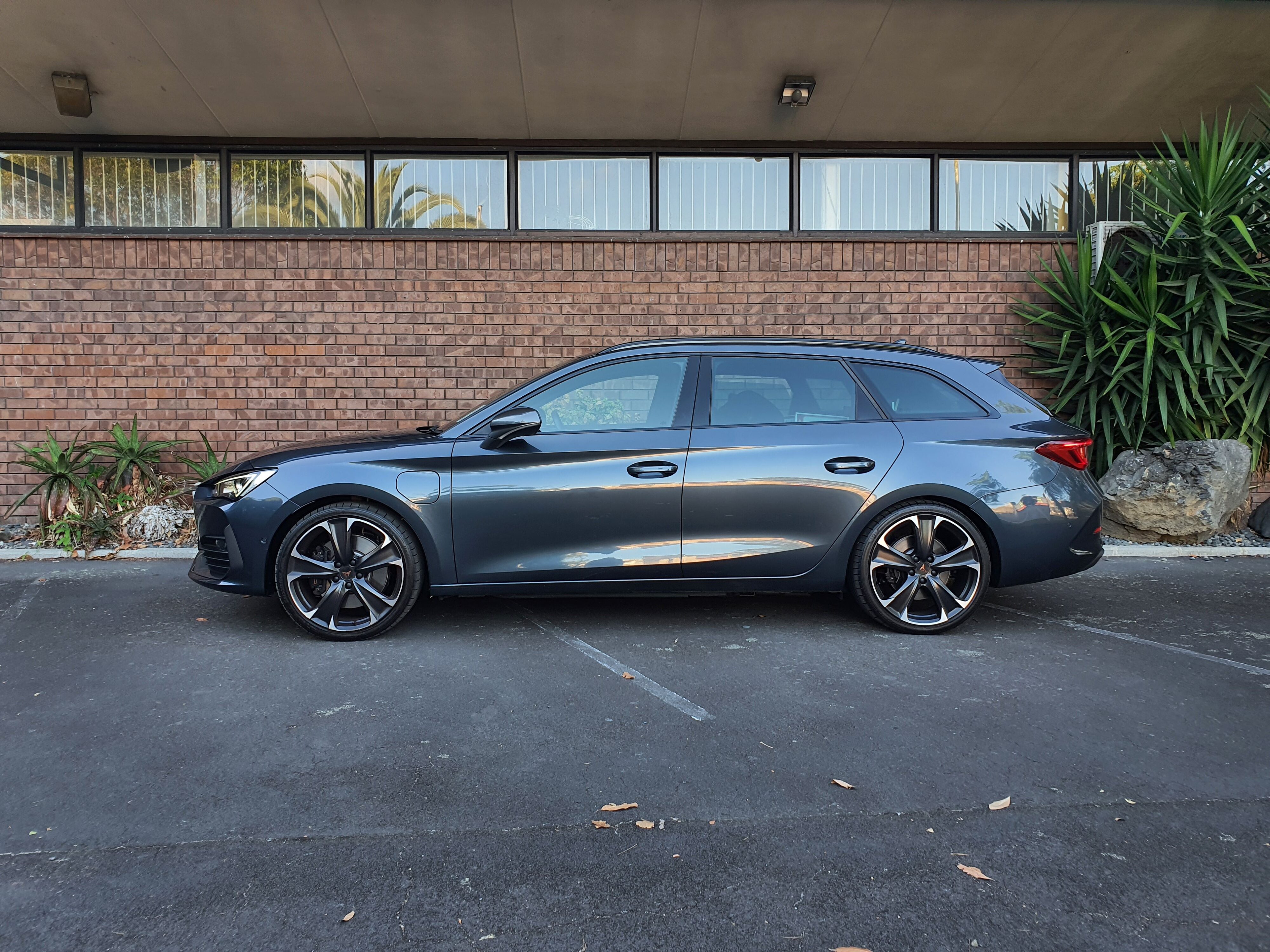 Side on view of a 2024 Cupra Leon V Sportstourer e-HYBRID in Magnetic Tech.