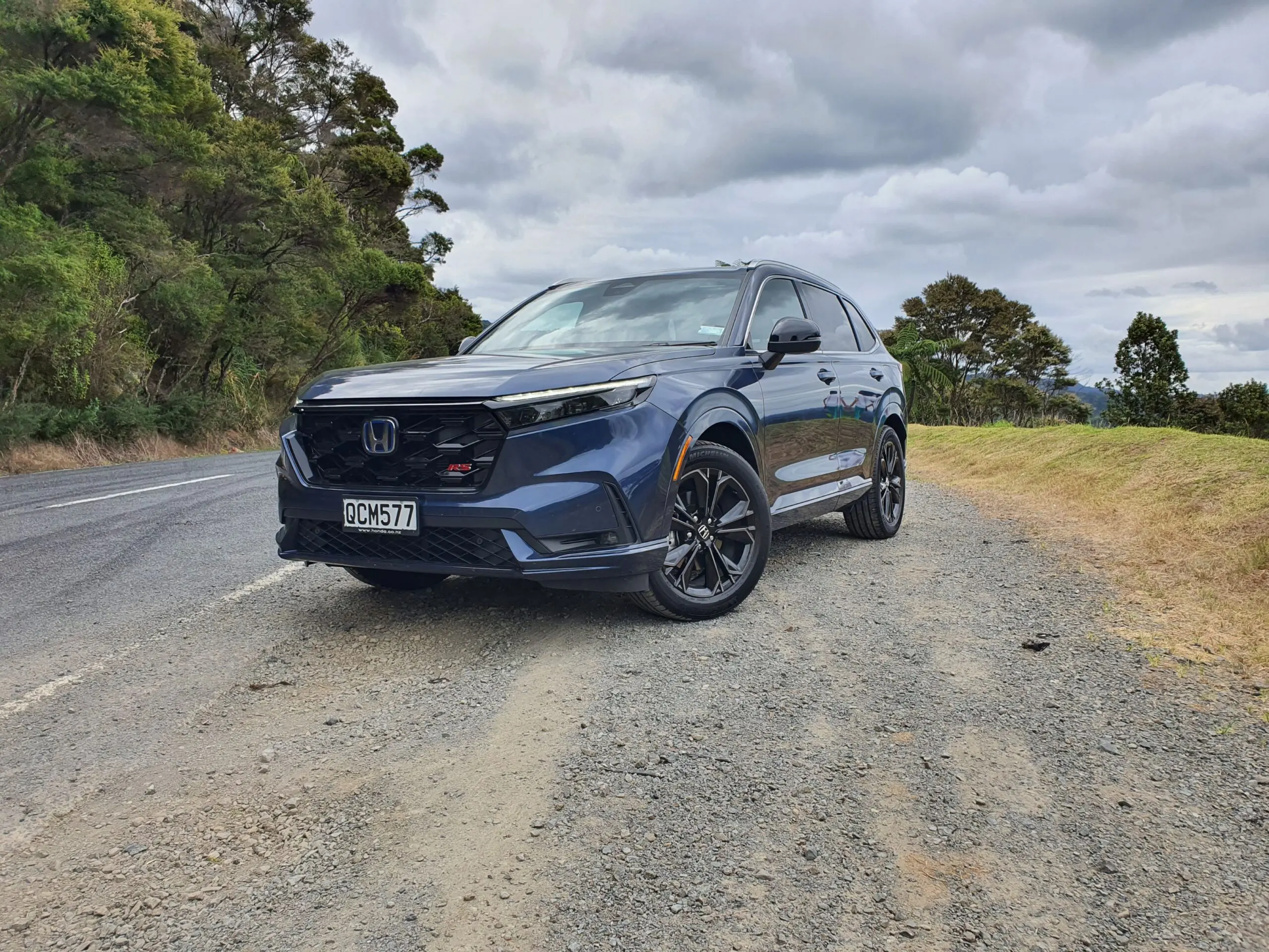 Front three quarters view of a 2024 Honda CR-V RS e:HEV in Canyon River Blue Metallic.