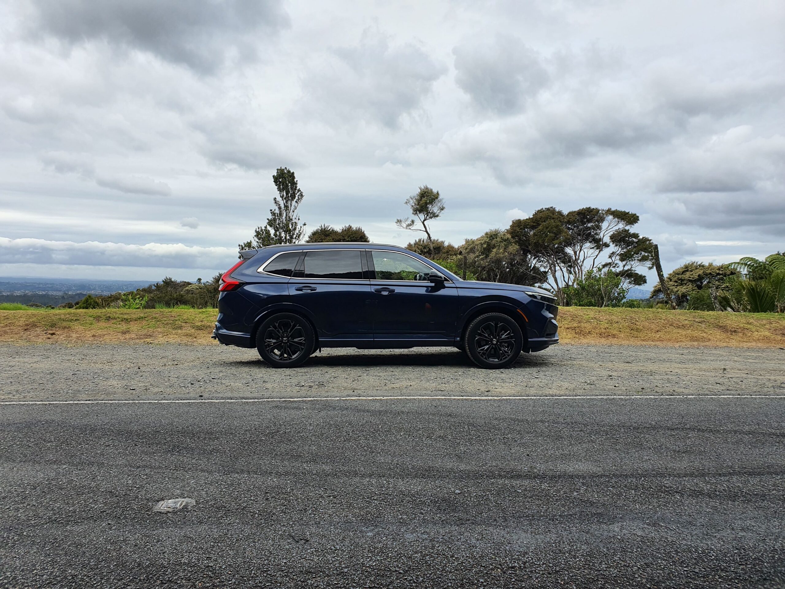 Side on view of a 2024 Honda CR-V RS e:HEV in Canyon River Blue Metallic.
