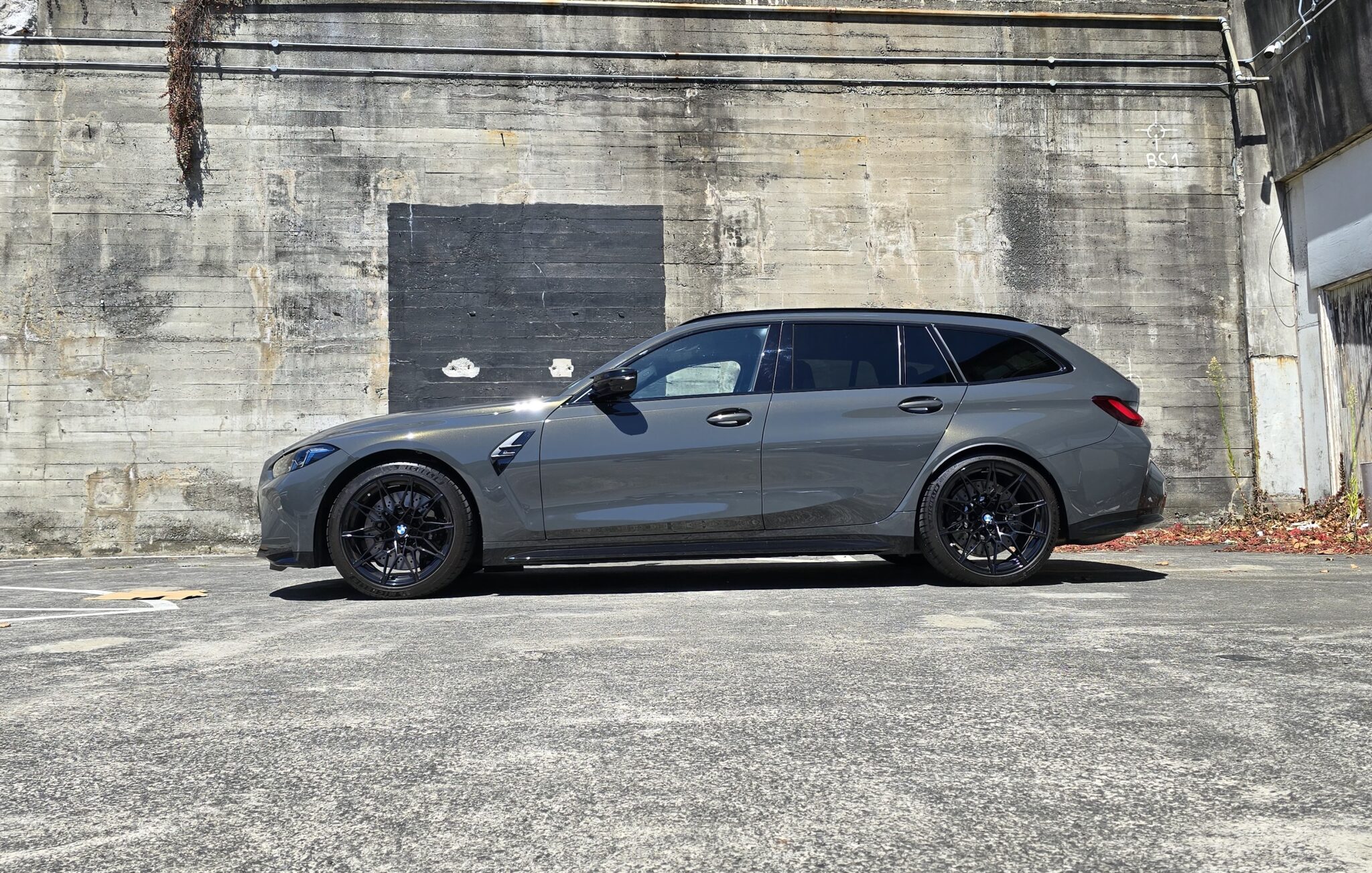 Bold and sporty BMW M3 Competition Touring with sharp lines and iconic grille.