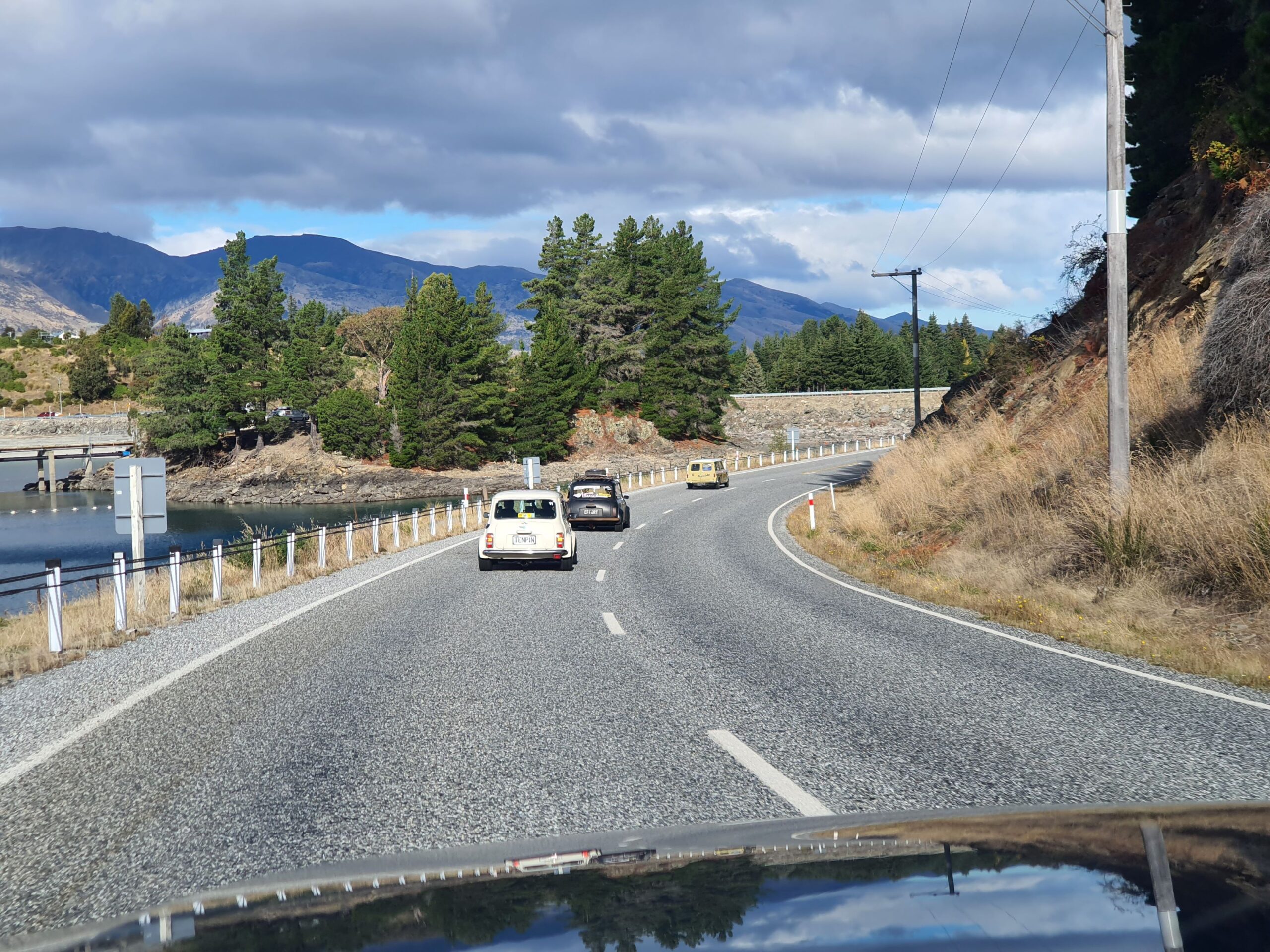 Three Minis drive towards The Remarkables on the way to Cromwell in New Zealand's South Island on the 2025 Pork Pie Charity Run.