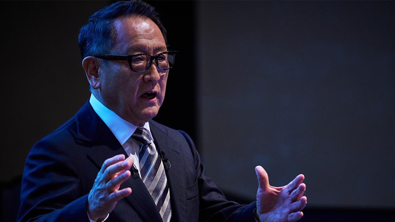 A photo of Akio Toyoda speaking at a public event.