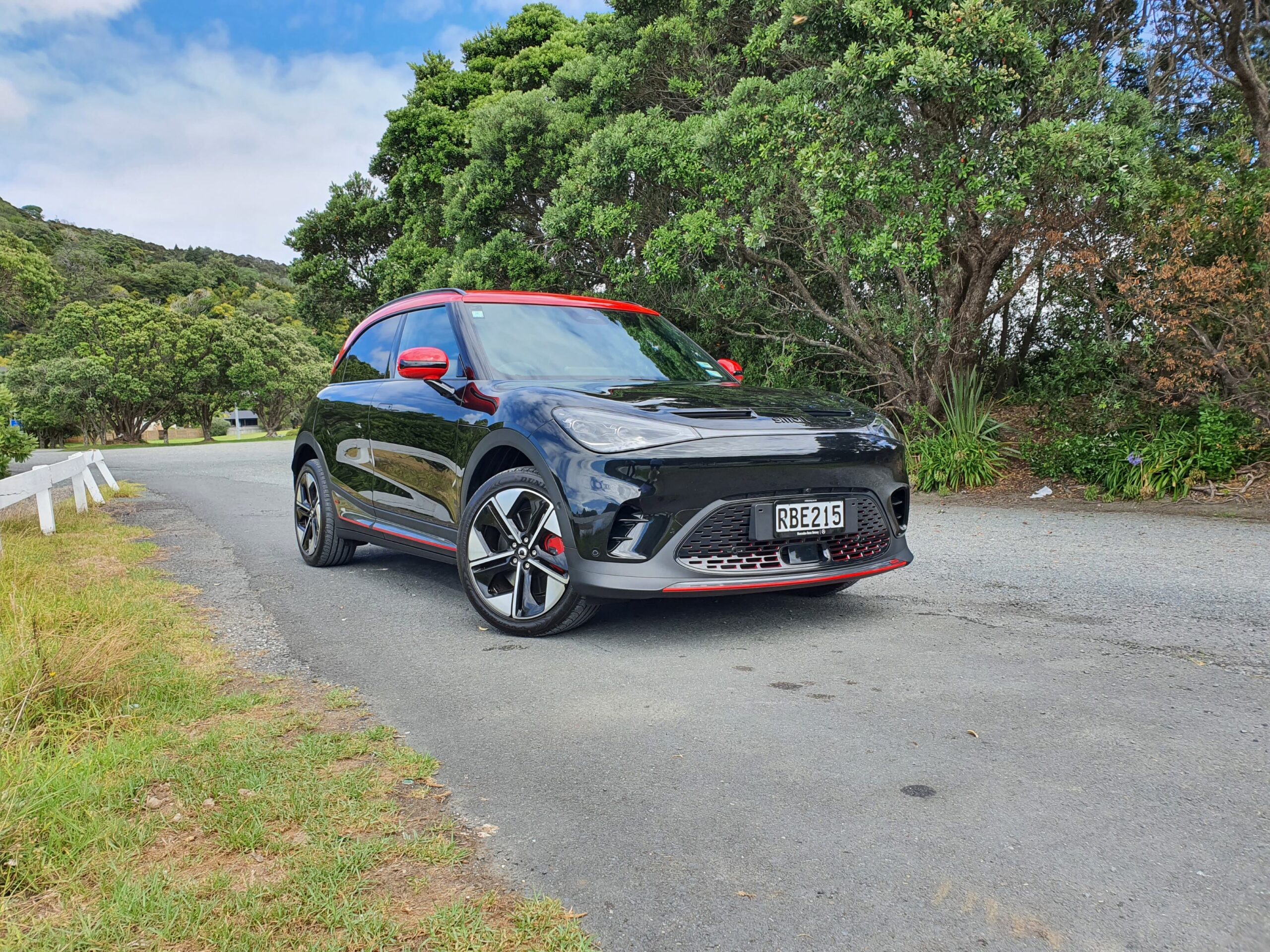 Front three quarters view of a 2025 smart #1 Brabus in black with a red roof.