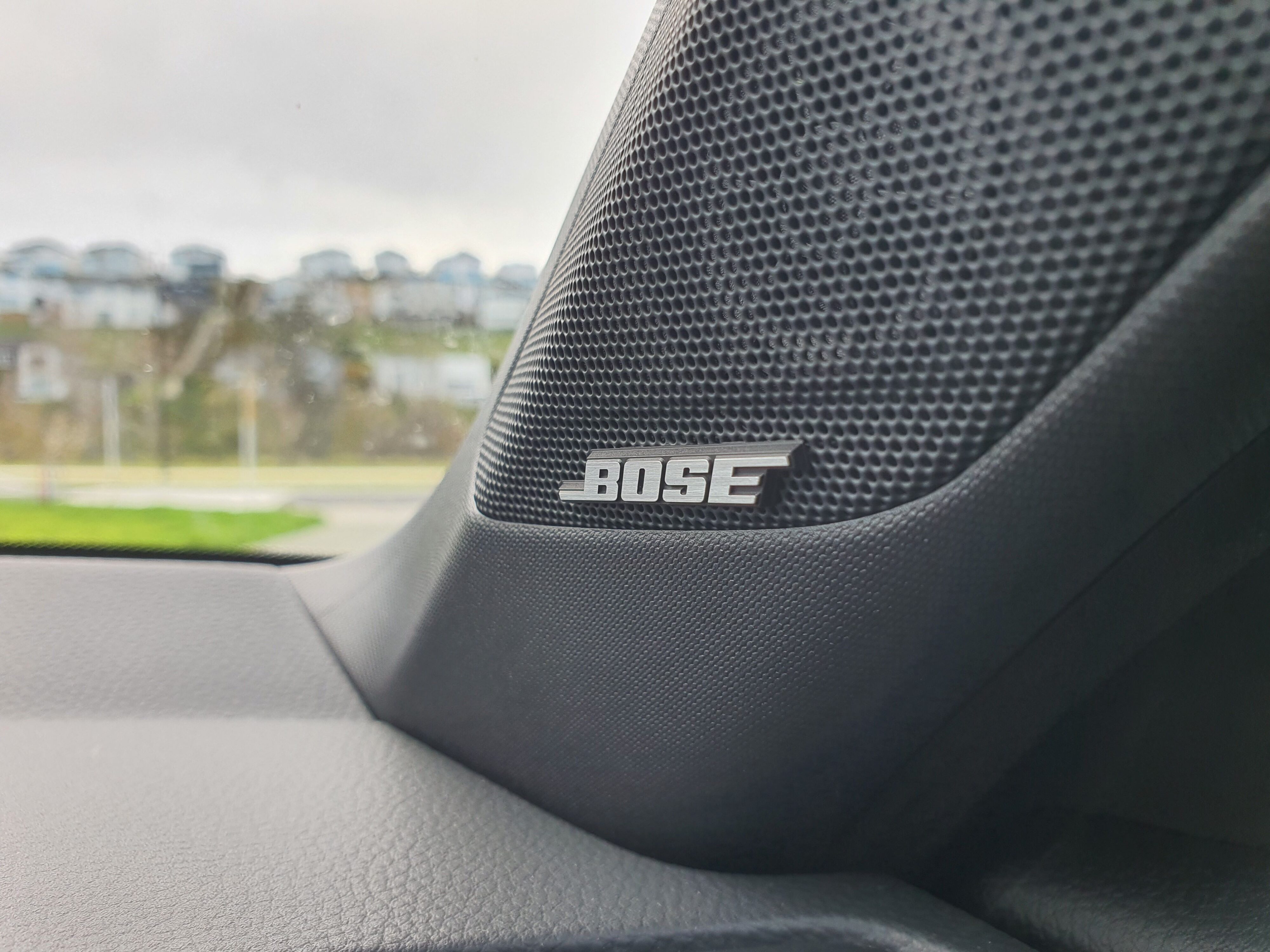 Bose badging on the a-pillar of a 2025 Honda Civic SR e:HEV highlighting the 12 speaker premium audio system.