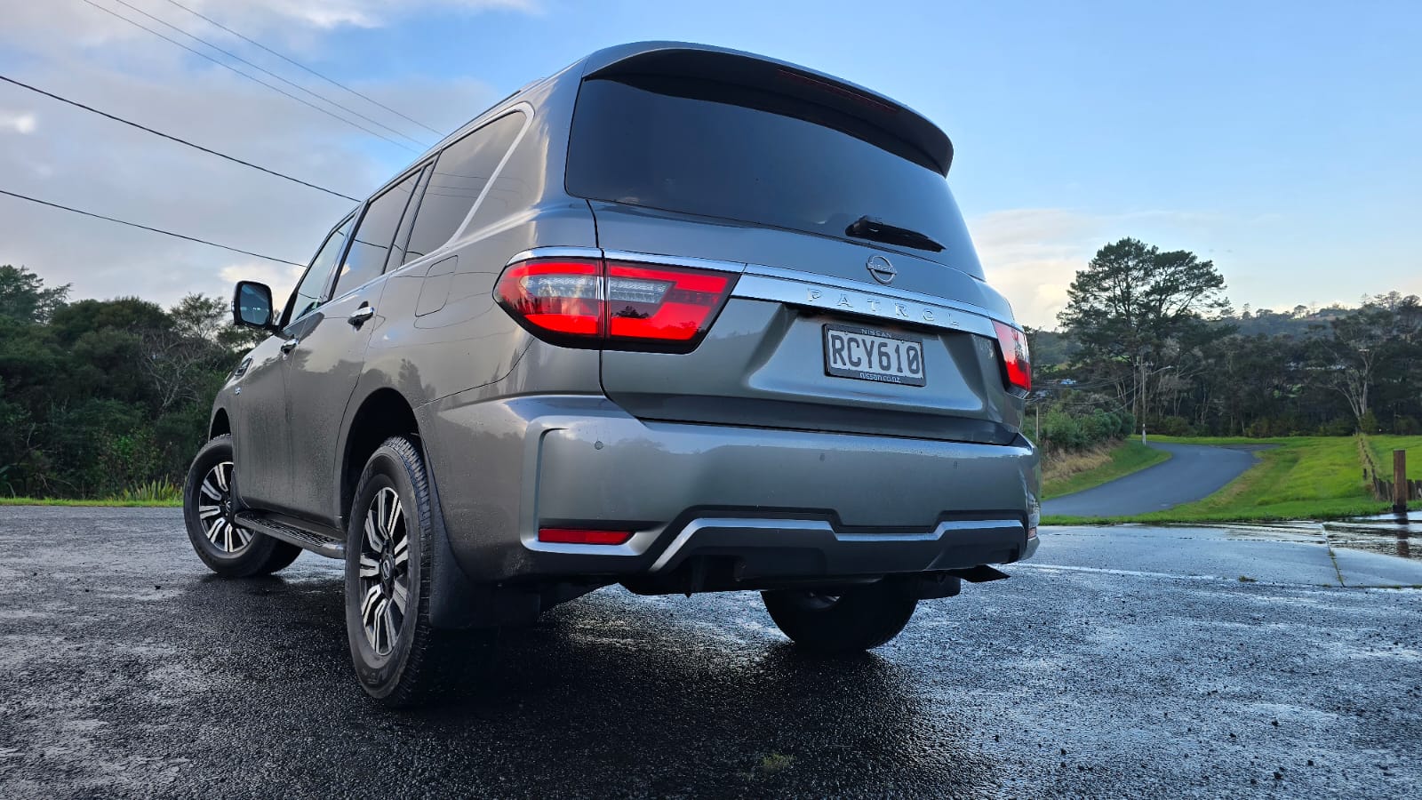 Rear three quarters view of a 2025 Nissan Patrol V8 in 'Gun Grey'.