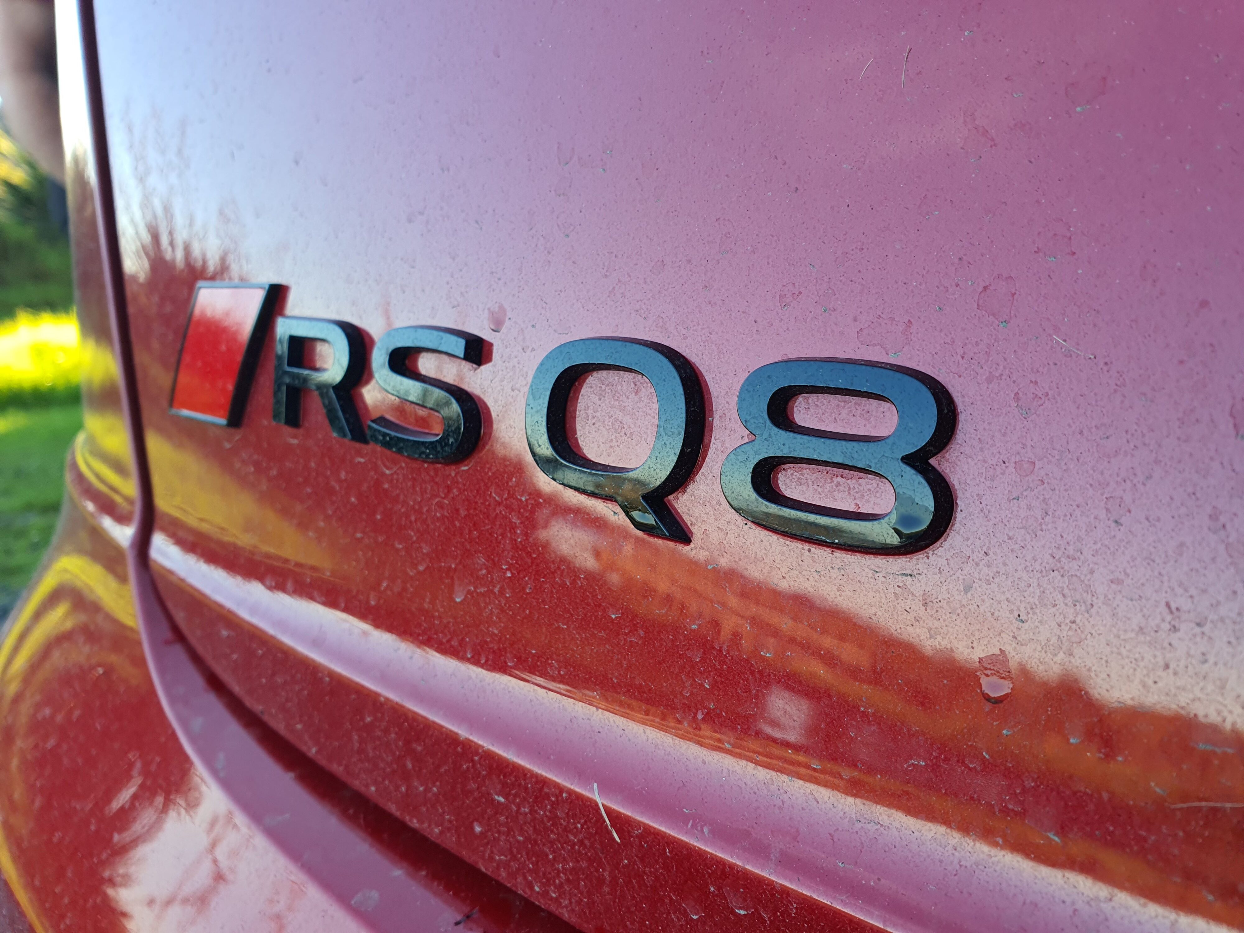 Close up photo of the RS Q8 badging on the rear of a 2025 Audi RS Q8 Performance in Chili Red.