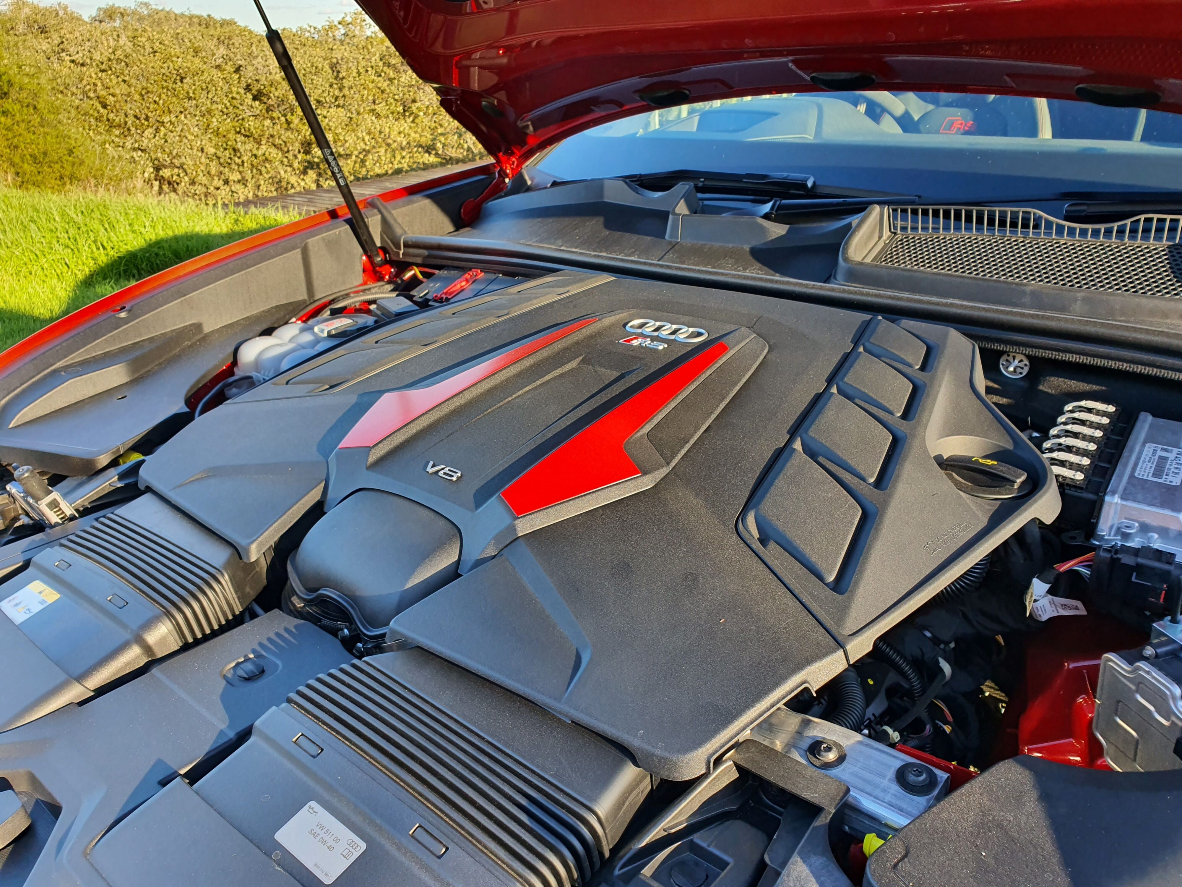A photo of the engine cover, hiding a 4 litre twin turbo V8 in the front of a 2025 Audi RS Q8 Performance.