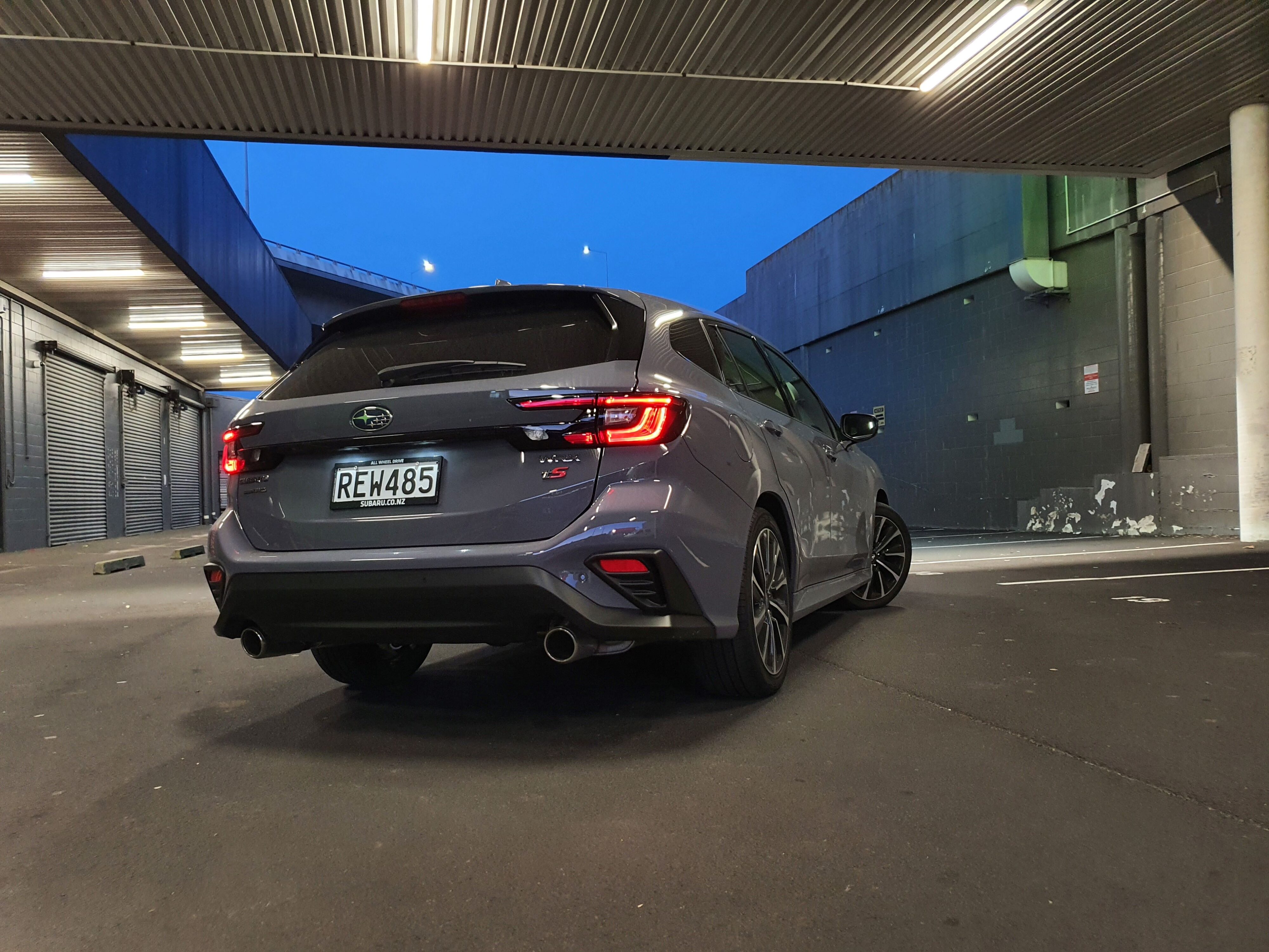 Rear three quarters view of a 2025 Subaru WRX GT tS Wagon in Asteroid Grey Pearl.