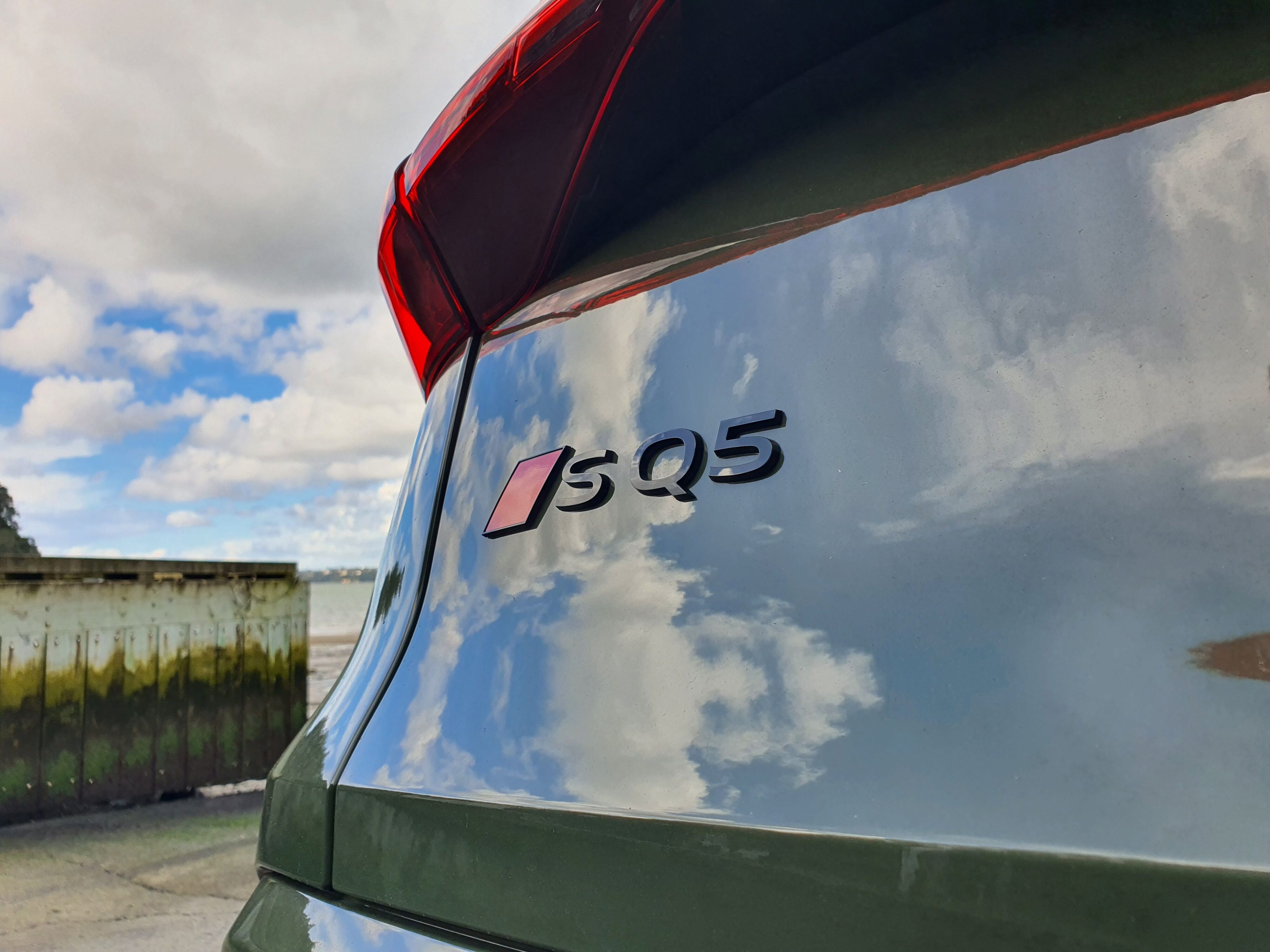 A photo of the SQ5 badge on tailgate of a 2025 Audi SQ5 in District Green.