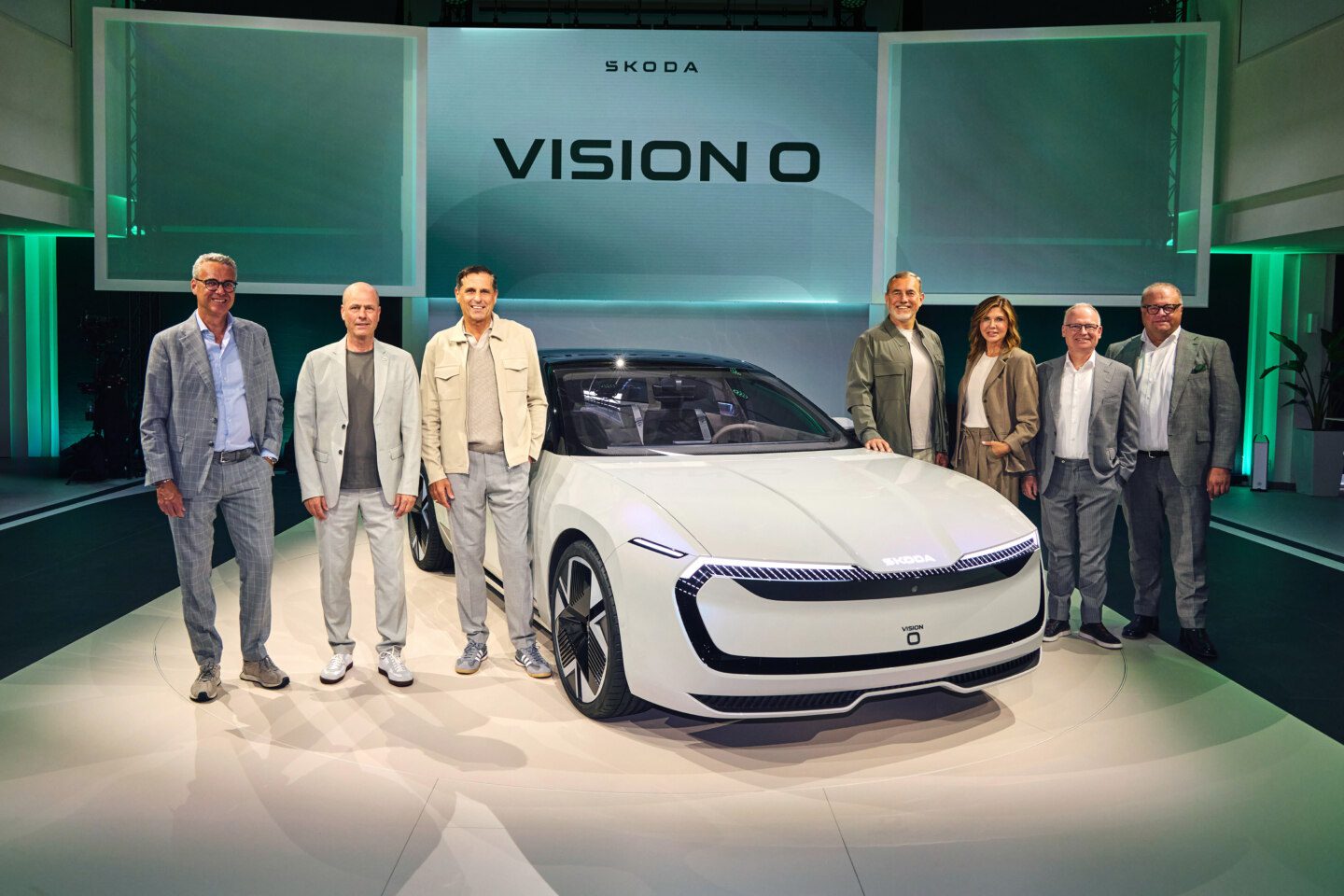 A photo of the Skoda Vision O at its unveiling, joined by senior executives from Skoda.