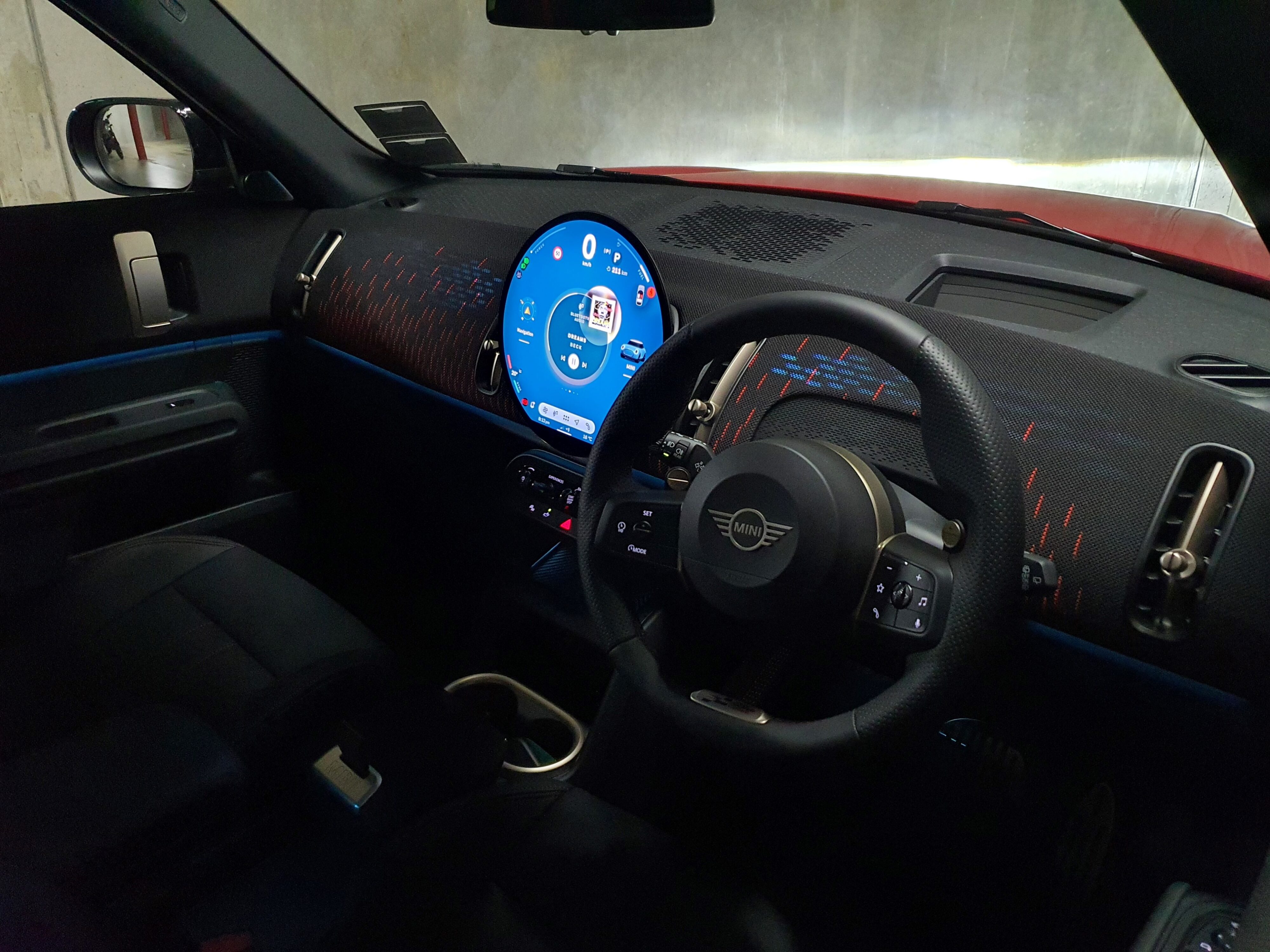Interior view of a 2025 Mini Countryman John Cooper Works in Red with a Black roof.