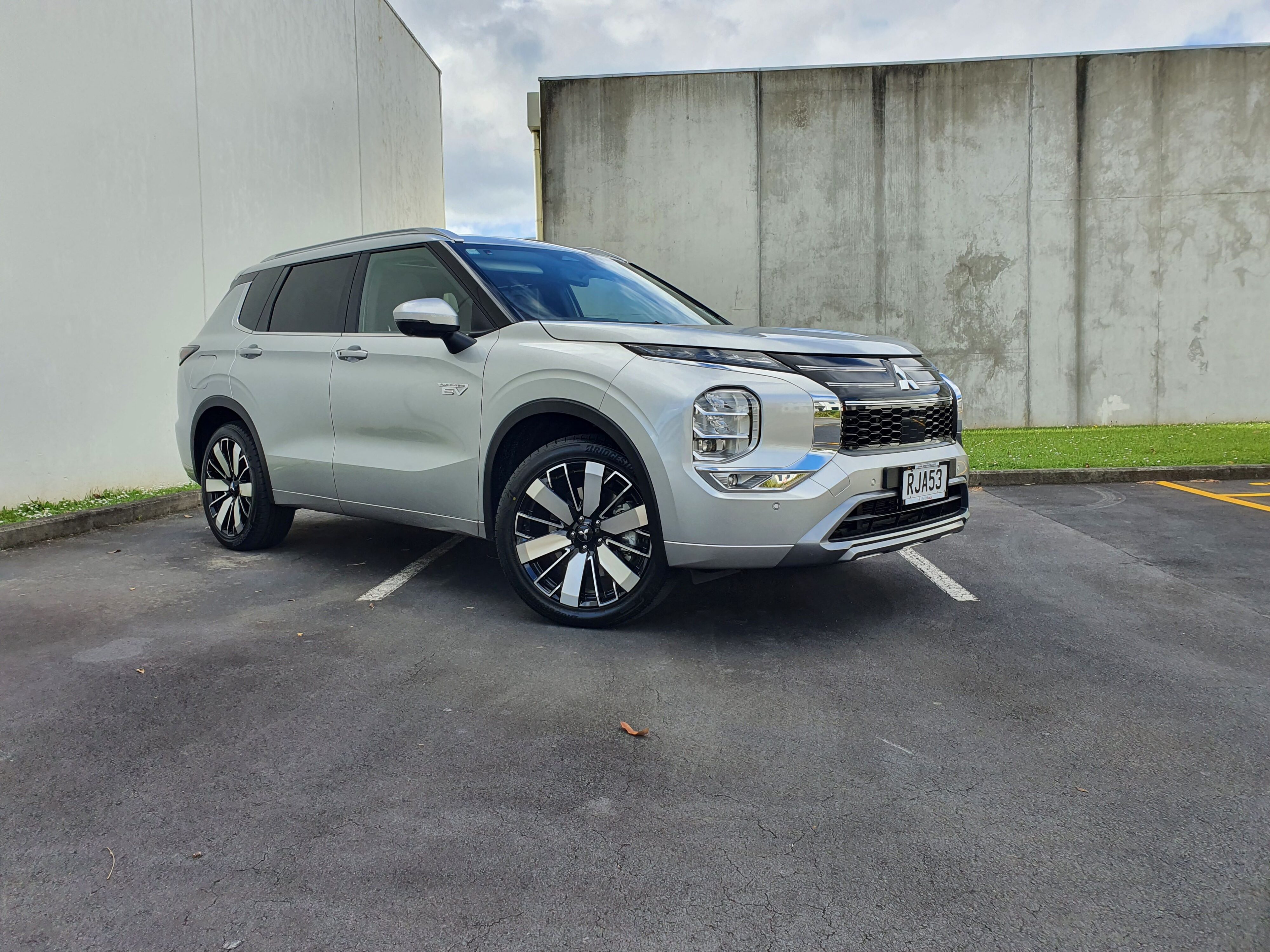 Front three quarters view of a 2025 Mitsubishi Outlander VRX PHEV in Silver.